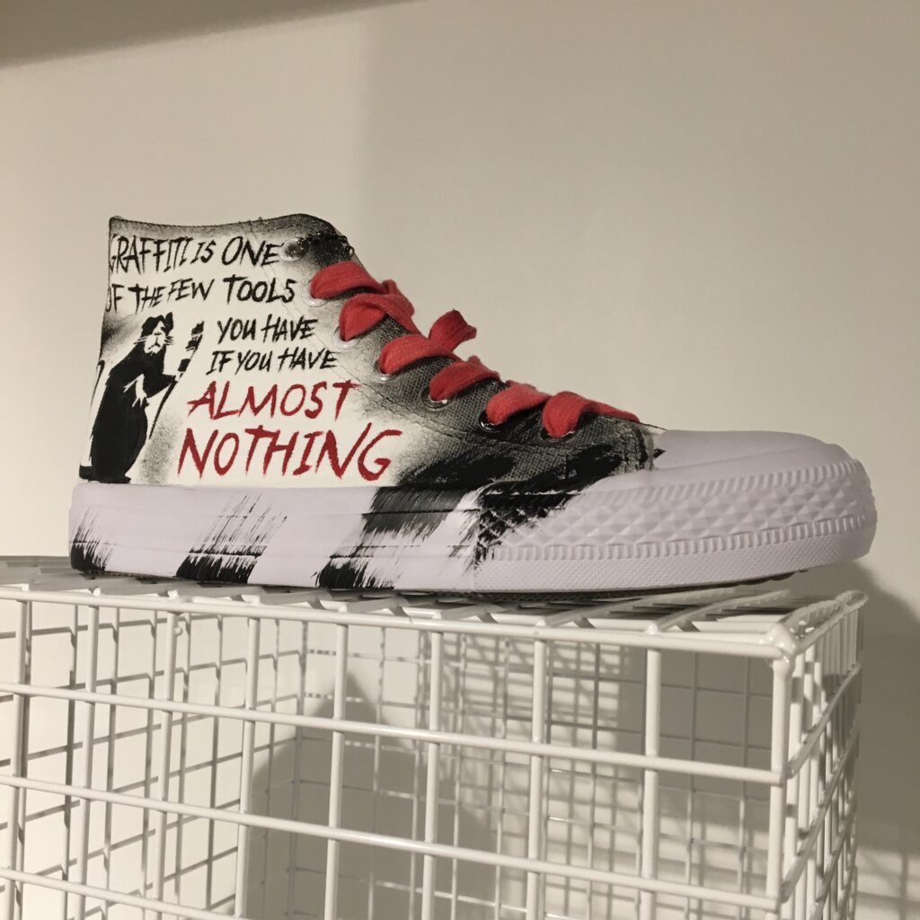The art of Banksy exhibition in Regent Street showcasing a customised sneakers